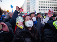 Citizens cheer after the impeachment of President Yoon Suk-yeol is passed in Seoul, South Korea, on December 14, 2024. Approximately 2 milli...