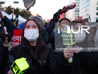 Citizens cheer after the impeachment of President Yoon Suk-yeol is passed in Seoul, South Korea, on December 14, 2024. Approximately 2 milli...