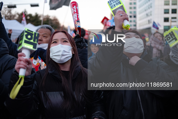 Citizens cheer after the impeachment of President Yoon Suk-yeol is passed in Seoul, South Korea, on December 14, 2024. Approximately 2 milli...