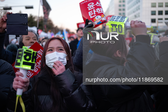 Citizens cheer after the impeachment of President Yoon Suk-yeol is passed in Seoul, South Korea, on December 14, 2024. Approximately 2 milli...