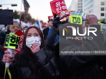 Citizens cheer after the impeachment of President Yoon Suk-yeol is passed in Seoul, South Korea, on December 14, 2024. Approximately 2 milli...