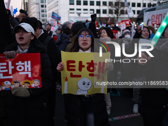 Citizens cheer after the impeachment of President Yoon Suk-yeol is passed in Seoul, South Korea, on December 14, 2024. Approximately 2 milli...