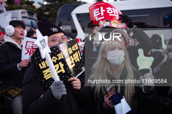 Citizens cheer after the impeachment of President Yoon Suk-yeol is passed in Seoul, South Korea, on December 14, 2024. Approximately 2 milli...