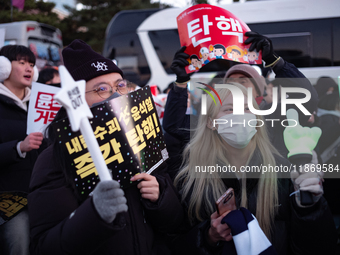 Citizens cheer after the impeachment of President Yoon Suk-yeol is passed in Seoul, South Korea, on December 14, 2024. Approximately 2 milli...