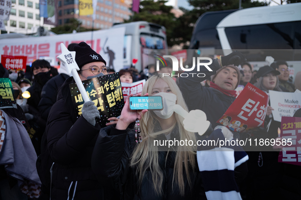 Citizens cheer after the impeachment of President Yoon Suk-yeol is passed in Seoul, South Korea, on December 14, 2024. Approximately 2 milli...