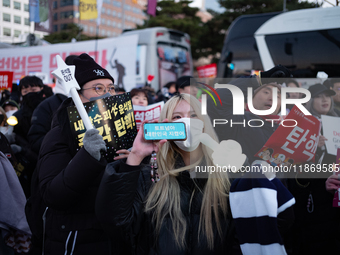 Citizens cheer after the impeachment of President Yoon Suk-yeol is passed in Seoul, South Korea, on December 14, 2024. Approximately 2 milli...