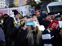 Citizens cheer after the impeachment of President Yoon Suk-yeol is passed in Seoul, South Korea, on December 14, 2024. Approximately 2 milli...