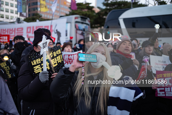 Citizens cheer after the impeachment of President Yoon Suk-yeol is passed in Seoul, South Korea, on December 14, 2024. Approximately 2 milli...