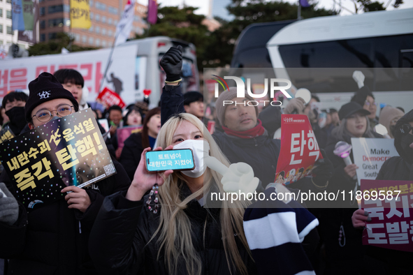 Citizens cheer after the impeachment of President Yoon Suk-yeol is passed in Seoul, South Korea, on December 14, 2024. Approximately 2 milli...