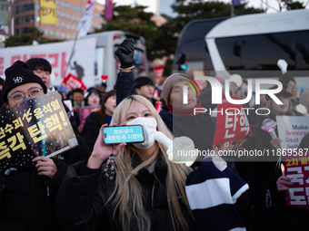 Citizens cheer after the impeachment of President Yoon Suk-yeol is passed in Seoul, South Korea, on December 14, 2024. Approximately 2 milli...