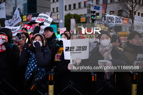 Citizens cheer after the impeachment of President Yoon Suk-yeol is passed in Seoul, South Korea, on December 14, 2024. Approximately 2 milli...