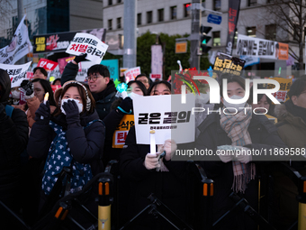 Citizens cheer after the impeachment of President Yoon Suk-yeol is passed in Seoul, South Korea, on December 14, 2024. Approximately 2 milli...