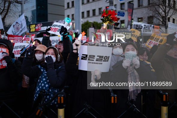 Citizens cheer after the impeachment of President Yoon Suk-yeol is passed in Seoul, South Korea, on December 14, 2024. Approximately 2 milli...