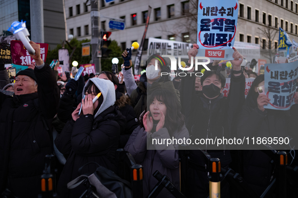 Citizens cheer after the impeachment of President Yoon Suk-yeol is passed in Seoul, South Korea, on December 14, 2024. Approximately 2 milli...