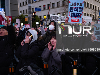 Citizens cheer after the impeachment of President Yoon Suk-yeol is passed in Seoul, South Korea, on December 14, 2024. Approximately 2 milli...