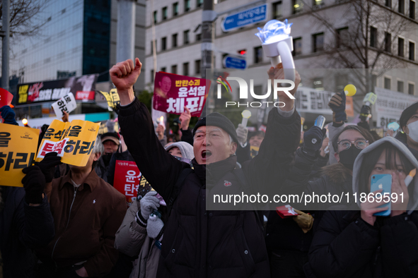 Citizens cheer after the impeachment of President Yoon Suk-yeol is passed in Seoul, South Korea, on December 14, 2024. Approximately 2 milli...