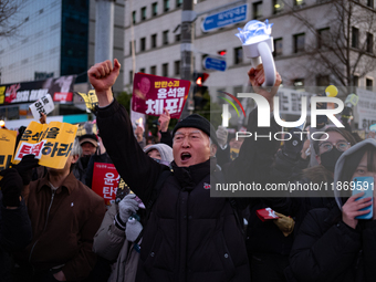 Citizens cheer after the impeachment of President Yoon Suk-yeol is passed in Seoul, South Korea, on December 14, 2024. Approximately 2 milli...