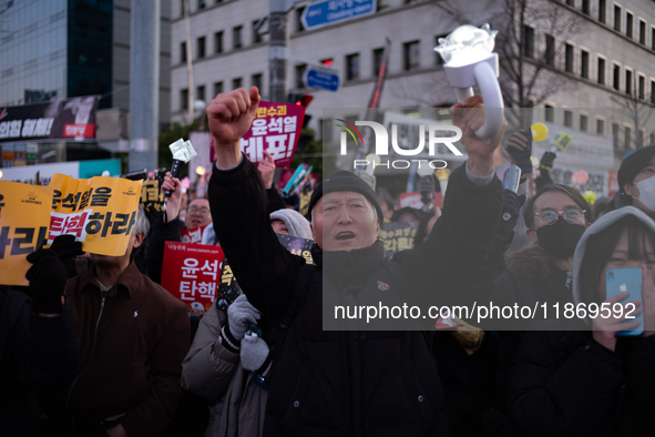 Citizens cheer after the impeachment of President Yoon Suk-yeol is passed in Seoul, South Korea, on December 14, 2024. Approximately 2 milli...