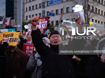 Citizens cheer after the impeachment of President Yoon Suk-yeol is passed in Seoul, South Korea, on December 14, 2024. Approximately 2 milli...