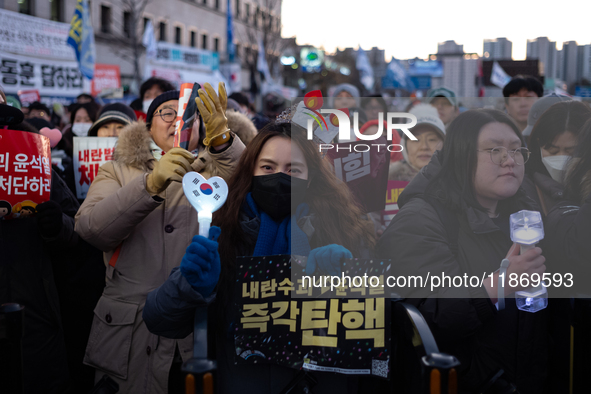 Citizens cheer after the impeachment of President Yoon Suk-yeol is passed in Seoul, South Korea, on December 14, 2024. Approximately 2 milli...