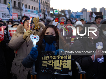 Citizens cheer after the impeachment of President Yoon Suk-yeol is passed in Seoul, South Korea, on December 14, 2024. Approximately 2 milli...