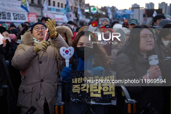 Citizens cheer after the impeachment of President Yoon Suk-yeol is passed in Seoul, South Korea, on December 14, 2024. Approximately 2 milli...