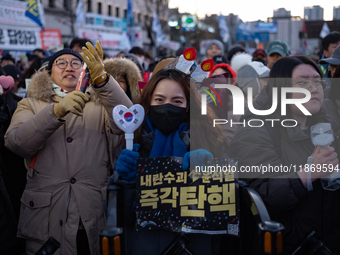 Citizens cheer after the impeachment of President Yoon Suk-yeol is passed in Seoul, South Korea, on December 14, 2024. Approximately 2 milli...