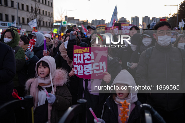 Citizens cheer after the impeachment of President Yoon Suk-yeol is passed in Seoul, South Korea, on December 14, 2024. Approximately 2 milli...