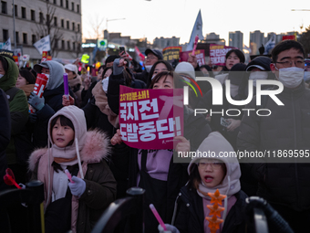 Citizens cheer after the impeachment of President Yoon Suk-yeol is passed in Seoul, South Korea, on December 14, 2024. Approximately 2 milli...