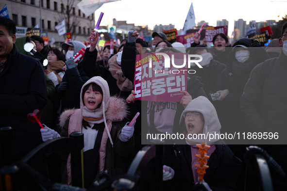 Citizens cheer after the impeachment of President Yoon Suk-yeol is passed in Seoul, South Korea, on December 14, 2024. Approximately 2 milli...