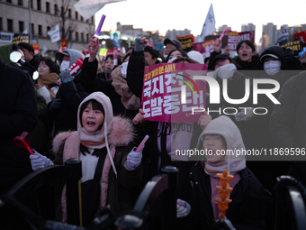 Citizens cheer after the impeachment of President Yoon Suk-yeol is passed in Seoul, South Korea, on December 14, 2024. Approximately 2 milli...