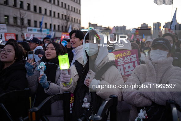 Citizens cheer after the impeachment of President Yoon Suk-yeol is passed in Seoul, South Korea, on December 14, 2024. Approximately 2 milli...