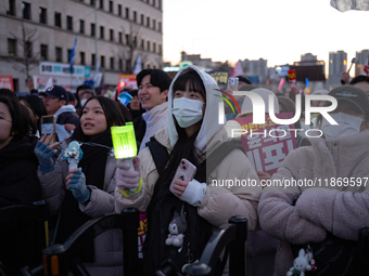 Citizens cheer after the impeachment of President Yoon Suk-yeol is passed in Seoul, South Korea, on December 14, 2024. Approximately 2 milli...