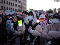 Citizens cheer after the impeachment of President Yoon Suk-yeol is passed in Seoul, South Korea, on December 14, 2024. Approximately 2 milli...