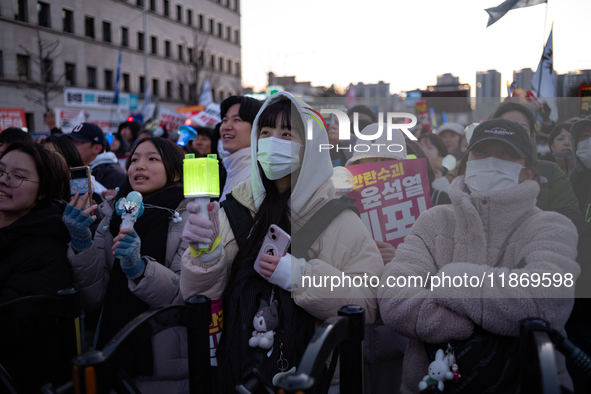 Citizens cheer after the impeachment of President Yoon Suk-yeol is passed in Seoul, South Korea, on December 14, 2024. Approximately 2 milli...