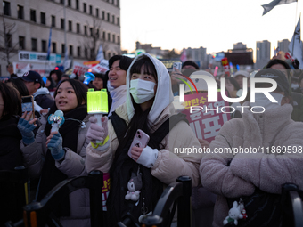 Citizens cheer after the impeachment of President Yoon Suk-yeol is passed in Seoul, South Korea, on December 14, 2024. Approximately 2 milli...