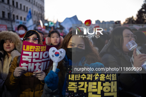 Citizens cheer after the impeachment of President Yoon Suk-yeol is passed in Seoul, South Korea, on December 14, 2024. Approximately 2 milli...