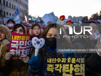 Citizens cheer after the impeachment of President Yoon Suk-yeol is passed in Seoul, South Korea, on December 14, 2024. Approximately 2 milli...