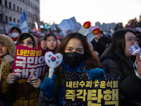 Citizens cheer after the impeachment of President Yoon Suk-yeol is passed in Seoul, South Korea, on December 14, 2024. Approximately 2 milli...