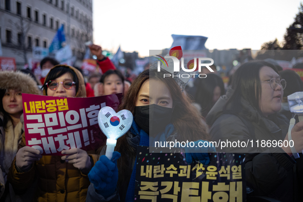 Citizens cheer after the impeachment of President Yoon Suk-yeol is passed in Seoul, South Korea, on December 14, 2024. Approximately 2 milli...