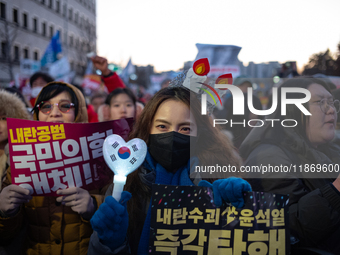 Citizens cheer after the impeachment of President Yoon Suk-yeol is passed in Seoul, South Korea, on December 14, 2024. Approximately 2 milli...