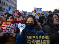 Citizens cheer after the impeachment of President Yoon Suk-yeol is passed in Seoul, South Korea, on December 14, 2024. Approximately 2 milli...