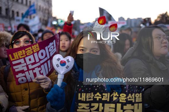 Citizens cheer after the impeachment of President Yoon Suk-yeol is passed in Seoul, South Korea, on December 14, 2024. Approximately 2 milli...