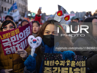 Citizens cheer after the impeachment of President Yoon Suk-yeol is passed in Seoul, South Korea, on December 14, 2024. Approximately 2 milli...