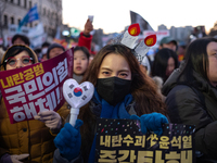 Citizens cheer after the impeachment of President Yoon Suk-yeol is passed in Seoul, South Korea, on December 14, 2024. Approximately 2 milli...