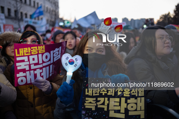 Citizens cheer after the impeachment of President Yoon Suk-yeol is passed in Seoul, South Korea, on December 14, 2024. Approximately 2 milli...