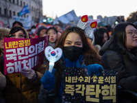 Citizens cheer after the impeachment of President Yoon Suk-yeol is passed in Seoul, South Korea, on December 14, 2024. Approximately 2 milli...