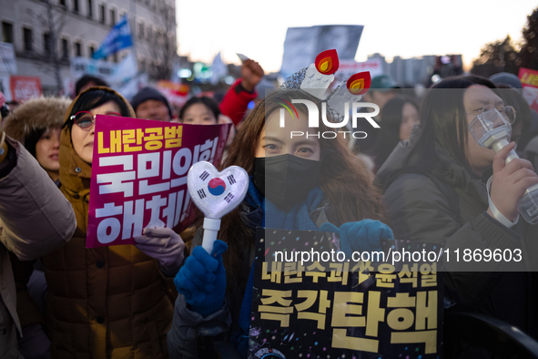 Citizens cheer after the impeachment of President Yoon Suk-yeol is passed in Seoul, South Korea, on December 14, 2024. Approximately 2 milli...