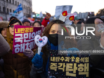 Citizens cheer after the impeachment of President Yoon Suk-yeol is passed in Seoul, South Korea, on December 14, 2024. Approximately 2 milli...