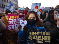 Citizens cheer after the impeachment of President Yoon Suk-yeol is passed in Seoul, South Korea, on December 14, 2024. Approximately 2 milli...